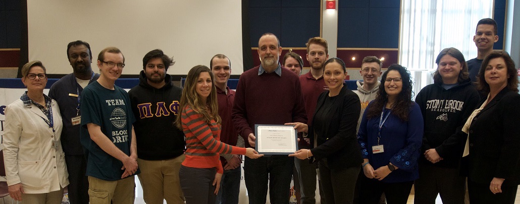 Blood drive New York Blood Center professional staff present award to Daria Carioscia and Paul Newland of the Staller Center with student members of the Student Blood Drive Committee